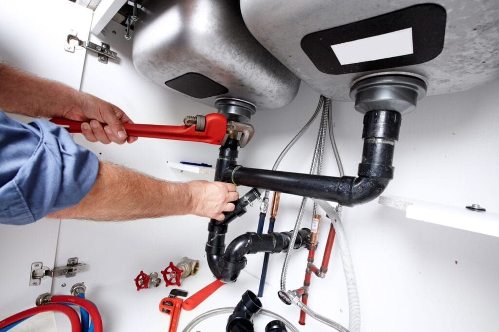 Peachtree Corners Plumbing Pros fixing under sink plumbing and drain pipes