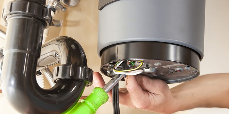 Peachtree Corners, Georgia plumber servicing water heater pipe connection